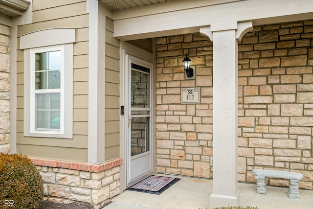 property entrance featuring brick siding