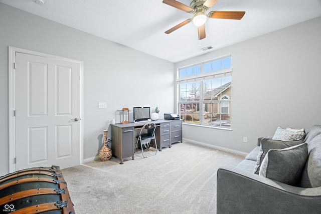 carpeted office with a ceiling fan, visible vents, and baseboards