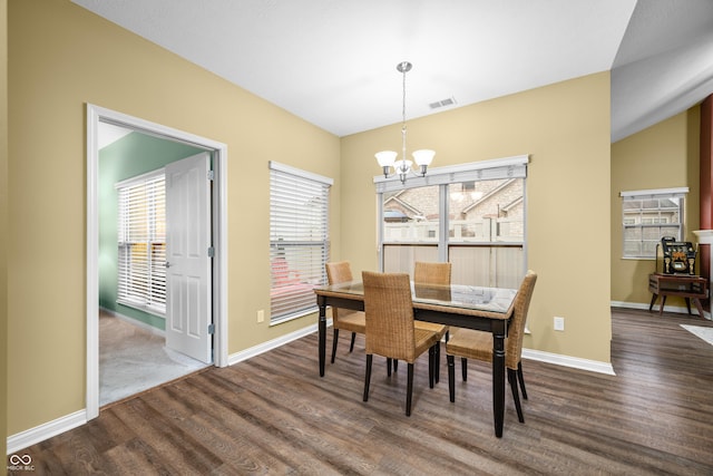 dining room with baseboards, dark wood-style flooring, visible vents, and a notable chandelier