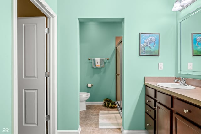 full bathroom featuring baseboards, toilet, a shower stall, and vanity