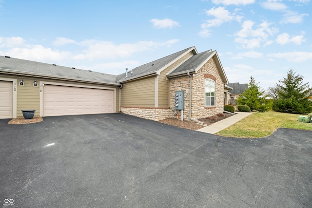 view of property exterior with a garage, stone siding, aphalt driveway, and roof with shingles