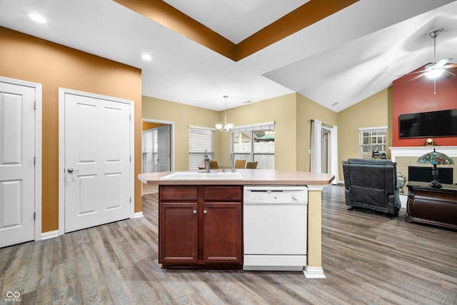 kitchen with a sink, open floor plan, dishwasher, and light countertops