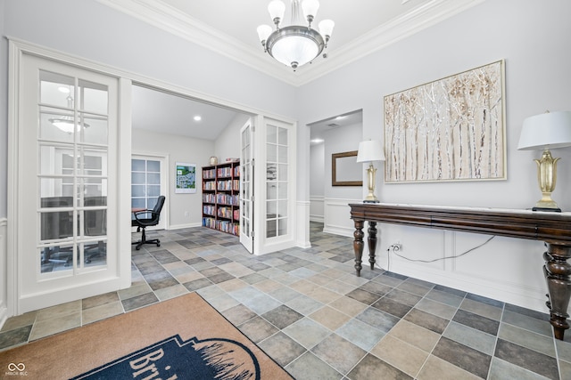 interior space featuring ornamental molding, french doors, and an inviting chandelier