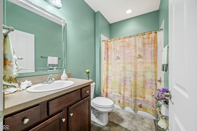 bathroom with toilet, shower / bath combo, wood finished floors, and vanity