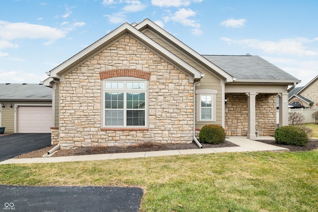 view of front facade with driveway, a shingled roof, a garage, and a front lawn