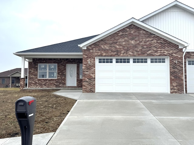 ranch-style house featuring a garage, brick siding, driveway, and roof with shingles