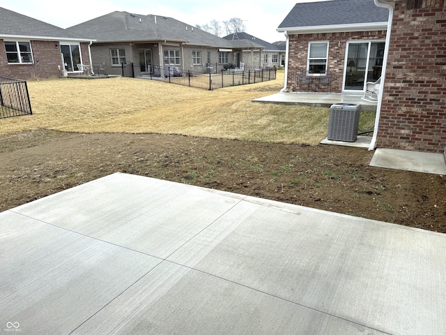 view of yard with central air condition unit, fence, and a patio