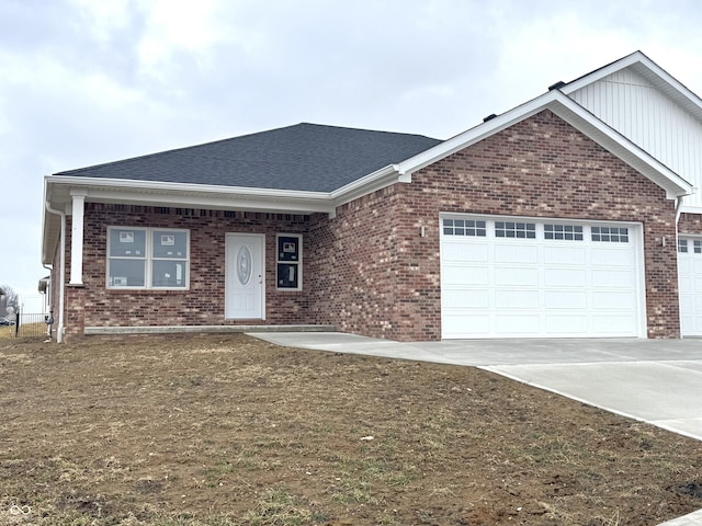 ranch-style home featuring driveway, brick siding, roof with shingles, and an attached garage