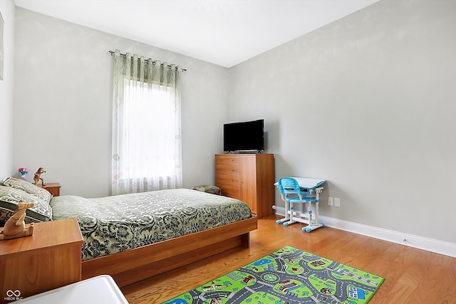 bedroom with wood finished floors and baseboards