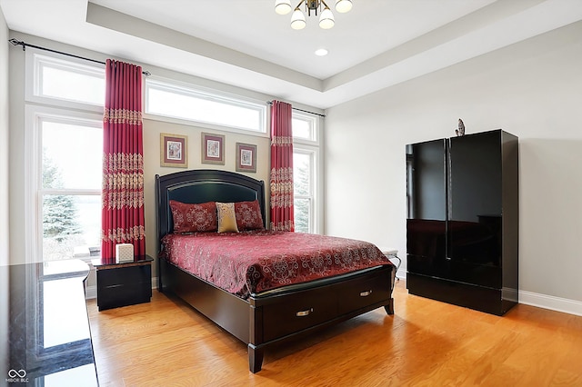 bedroom featuring light wood-style floors and baseboards