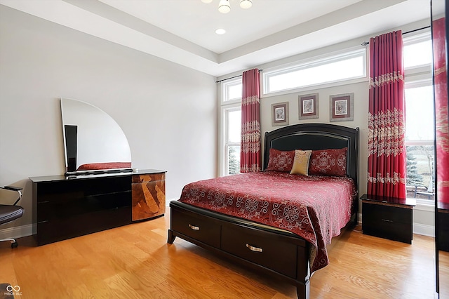 bedroom with baseboards and wood finished floors