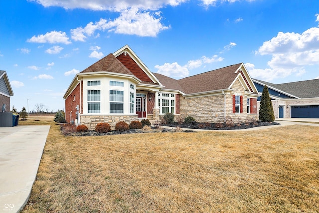 view of front facade featuring stone siding, a shingled roof, and a front yard