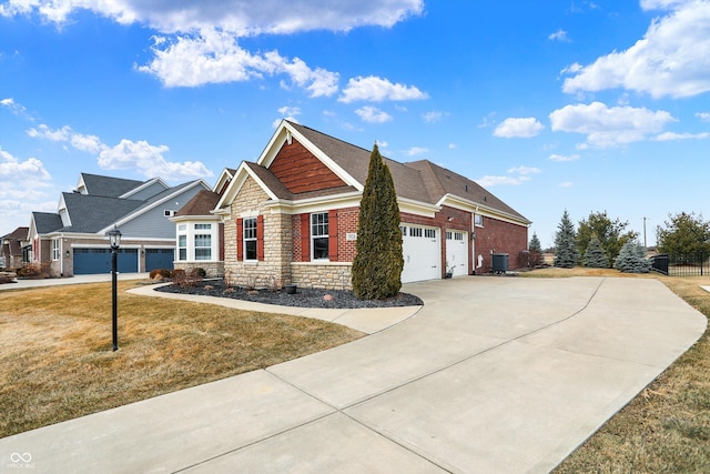 craftsman-style house with a garage, fence, stone siding, concrete driveway, and a front lawn