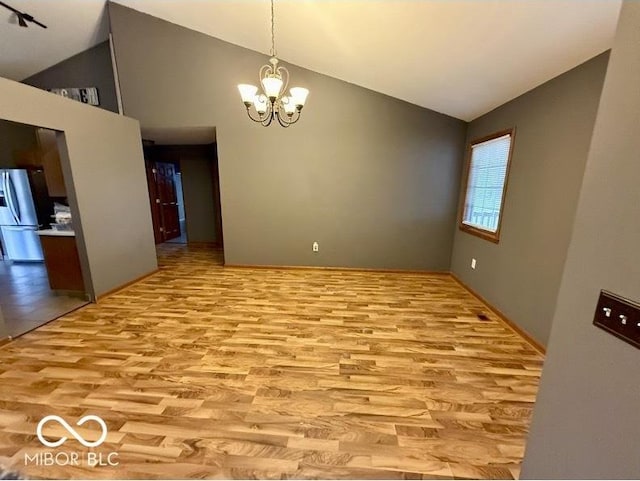 130 Hanover Dr, Morristown, IN 46161 - unfurnished dining area featuring light wood-type flooring, a chandelier, and high vaulted ceiling