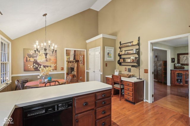 kitchen featuring light wood-style flooring, hanging light fixtures, light countertops, dishwasher, and a notable chandelier