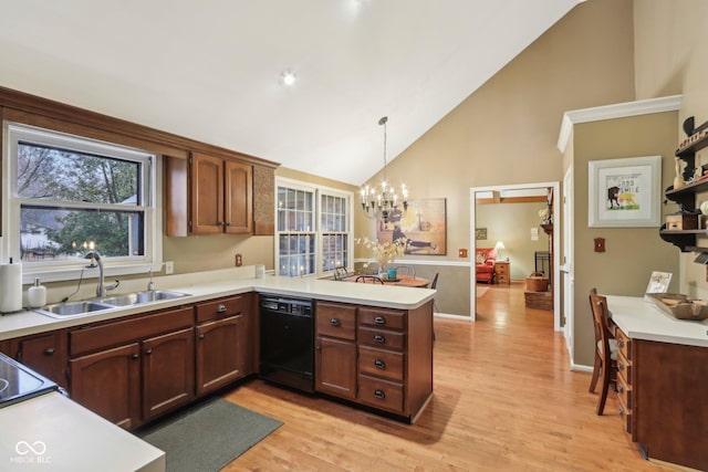 kitchen featuring a sink, a peninsula, light wood finished floors, dishwasher, and light countertops