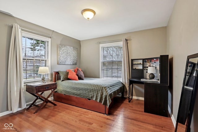 bedroom featuring baseboards and wood finished floors