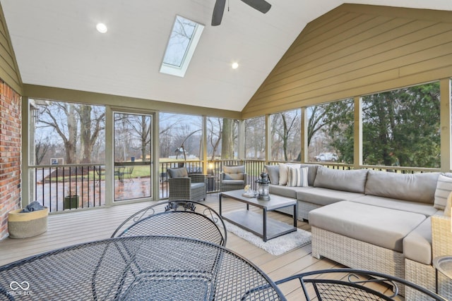 sunroom featuring vaulted ceiling with skylight and ceiling fan