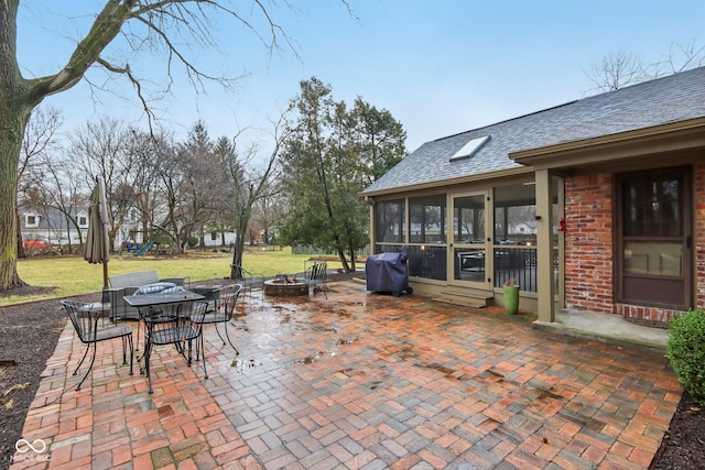 view of patio with a fire pit, a sunroom, and grilling area