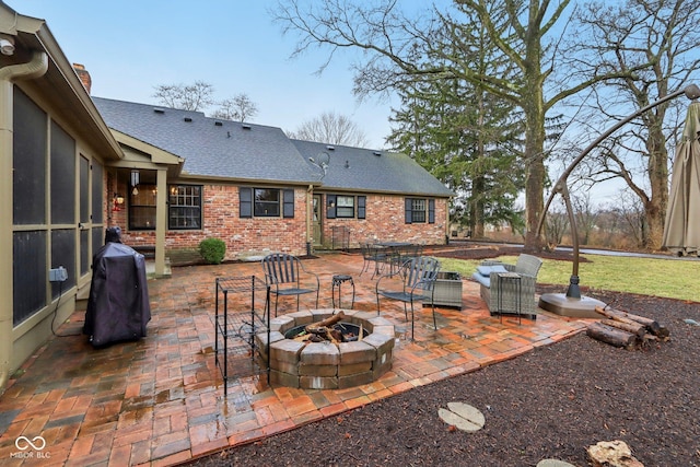 view of patio / terrace with a grill and a fire pit