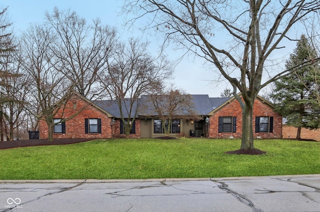 ranch-style house with brick siding and a front yard