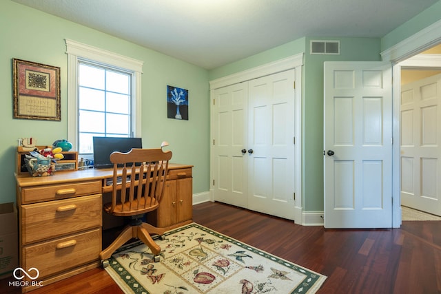 office space featuring dark wood-type flooring, visible vents, and baseboards