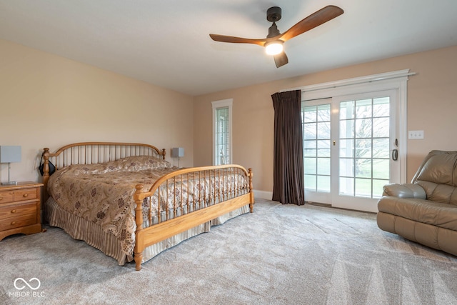 bedroom with carpet floors, access to exterior, and a ceiling fan