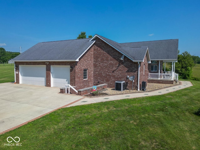 view of home's exterior featuring a garage, a lawn, central air condition unit, a porch, and brick siding