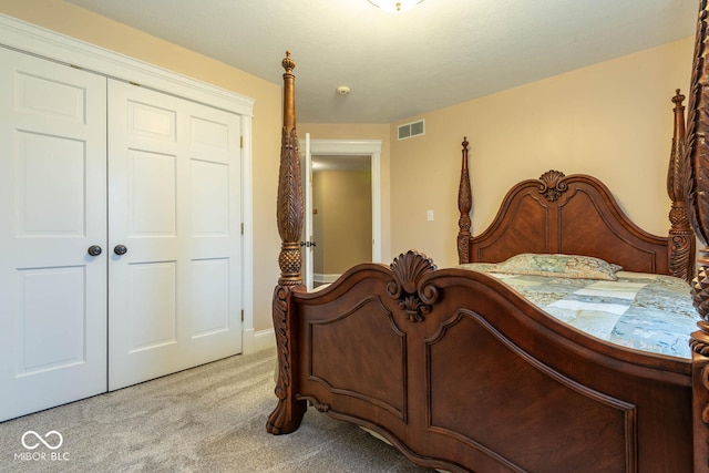 bedroom featuring a closet, light carpet, and visible vents