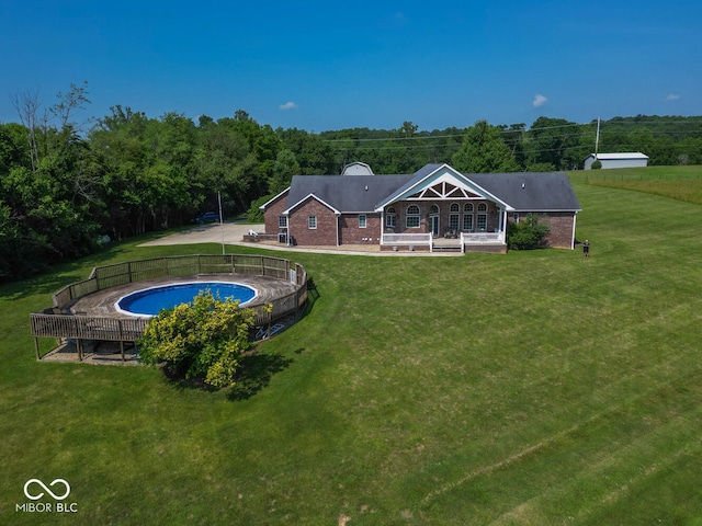 rear view of property featuring a yard