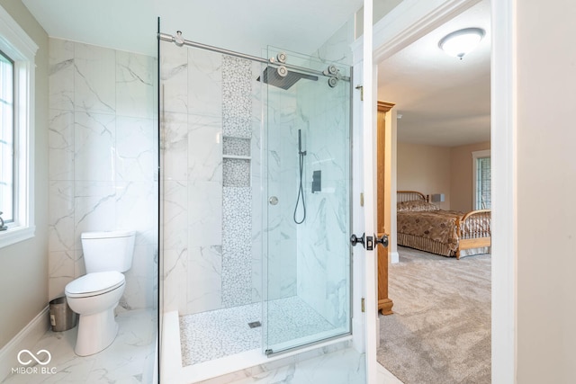 bathroom with marble finish floor, a marble finish shower, connected bathroom, and toilet