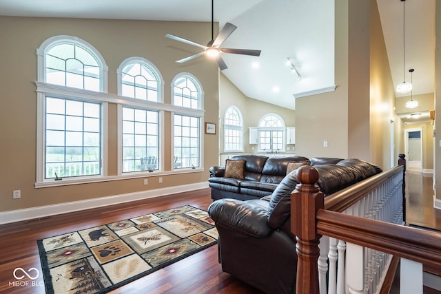 living area featuring visible vents, dark wood-type flooring, a ceiling fan, high vaulted ceiling, and baseboards