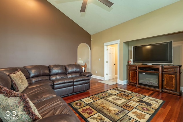 living area with arched walkways, high vaulted ceiling, a ceiling fan, baseboards, and dark wood-style floors