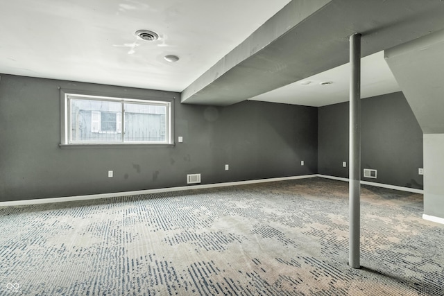 basement with visible vents and baseboards