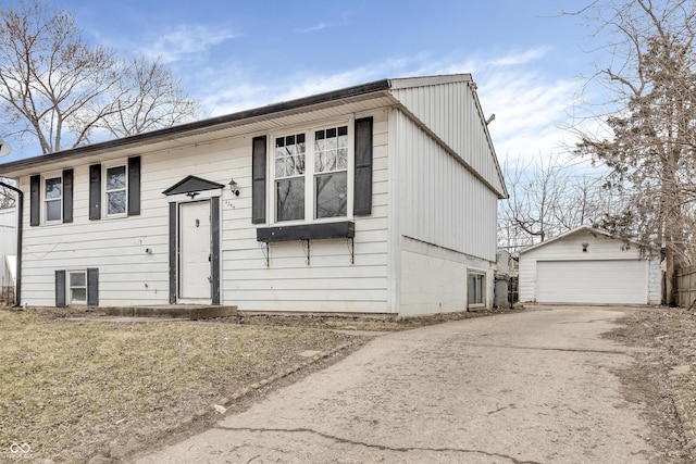 raised ranch featuring a detached garage and an outbuilding