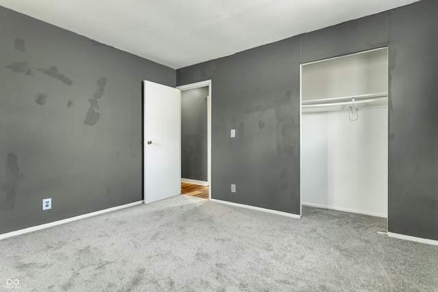 unfurnished bedroom featuring baseboards, a closet, and carpet flooring