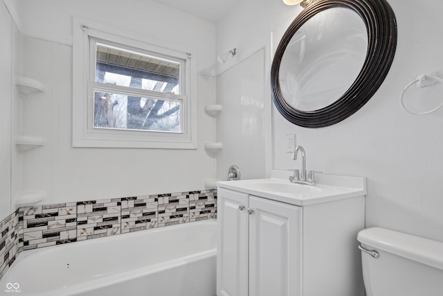 full bath with vanity, toilet, and a bath