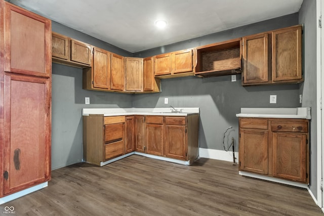 kitchen featuring open shelves, baseboards, brown cabinets, and dark wood-type flooring