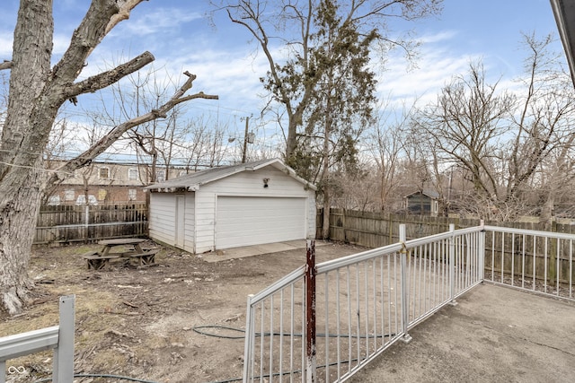 detached garage featuring fence