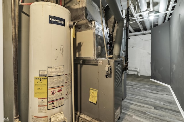 utility room featuring water heater and heating unit