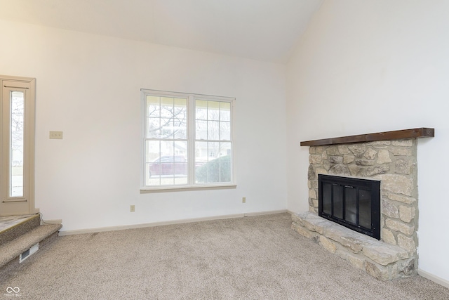 unfurnished living room with vaulted ceiling, carpet, and a healthy amount of sunlight