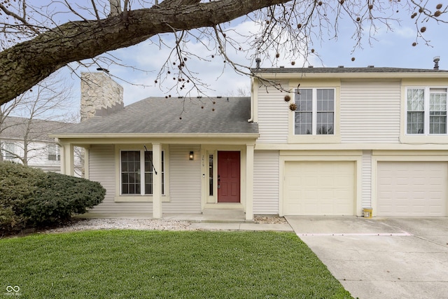 split level home with a garage, concrete driveway, a front lawn, and a chimney