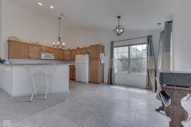 kitchen featuring white appliances, lofted ceiling, a peninsula, hanging light fixtures, and a chandelier