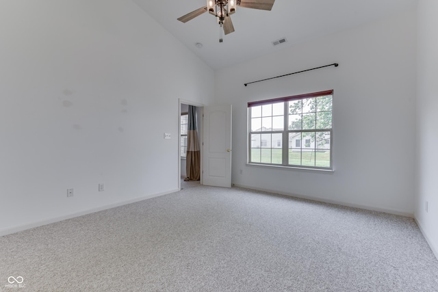 unfurnished room with high vaulted ceiling, light colored carpet, visible vents, and a ceiling fan