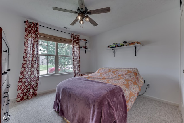 carpeted bedroom featuring visible vents, ceiling fan, and baseboards