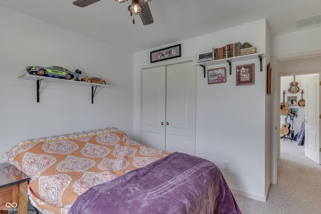 carpeted bedroom with baseboards, a closet, visible vents, and a ceiling fan