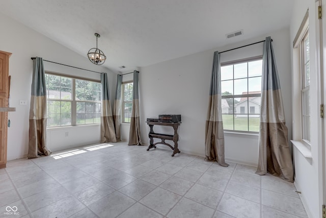 unfurnished room featuring a chandelier, lofted ceiling, a healthy amount of sunlight, and visible vents