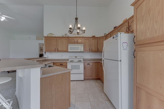 kitchen featuring light tile patterned floors, light countertops, a sink, high vaulted ceiling, and white appliances