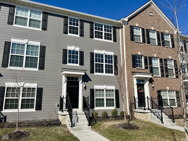 view of property featuring brick siding