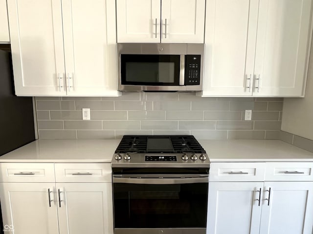 kitchen featuring light countertops, white cabinets, and appliances with stainless steel finishes